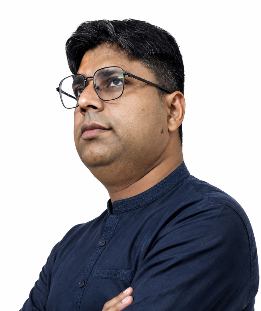Ankur Saxena wearing glasses and a dark blue kurta, looking upward in deep thought against a clean white background.